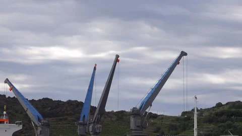 Cranes operate at a dock to load and unload cargo Stock Footage 342795900