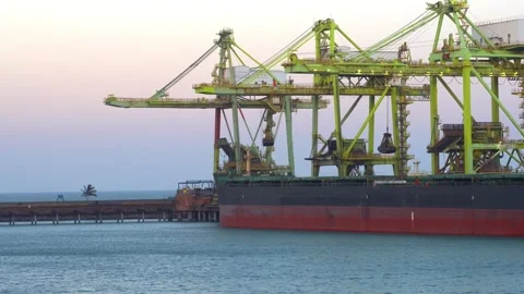 Cranes operating on a docked bulk carrier ship Stock Footage 345936769