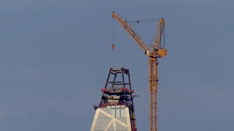A cranes sit in place over a skyscraper Stock Footage 95201153