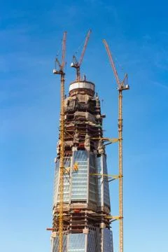 Cranes in the sky around the object. Stock Photos