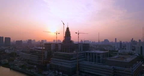 Cranes on top of building under construction next to main river in Bangkok Stock Footage 108573697