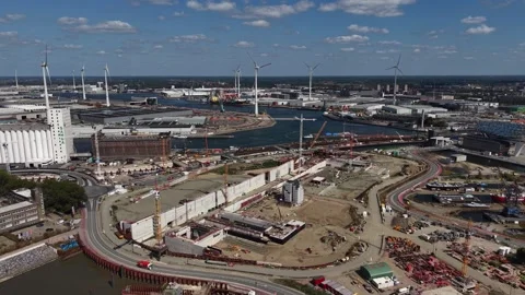 Cranes tower over active construction site near Antwerp container port, cargo Stock Footage 348251793