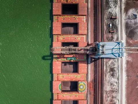 Cranes Unloading Cargo from a Bulk Carrier Ship at Port Stock Photos