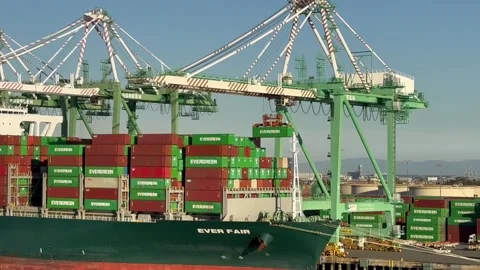 Cranes unloading a container ship in the port of Los Angeles Stock Footage 266060582