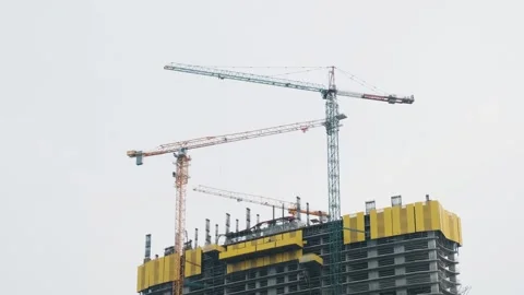 Cranes working on city construction site on the skyscraper rooftop. Building Stock Footage 269055030