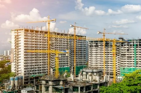 Cranes working on construct building Stock Photos