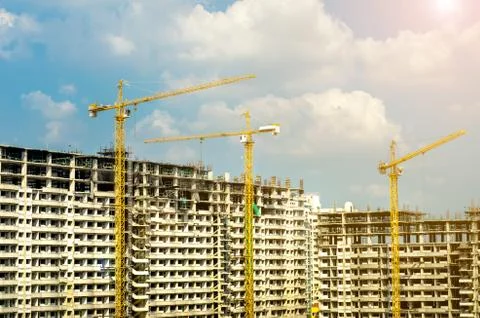 Cranes working on construct building Stock Photos