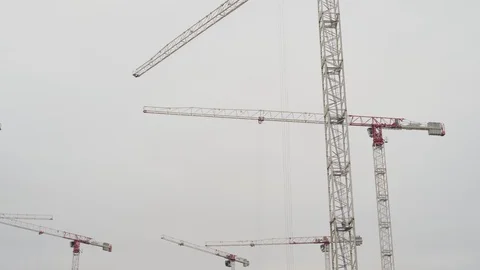 Cranes working on construction site under grey sky Stock Footage 127977925