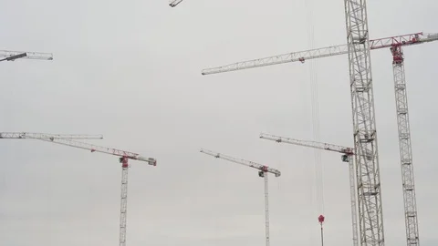 Cranes working on construction site under grey sky Stock Footage 127977926