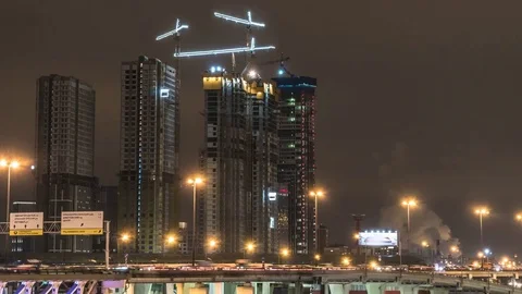 Cranes working day and night on construction of the housing estate in former  Stock Footage 84834116
