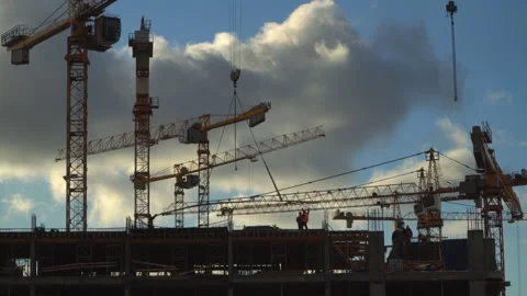 Cranes working day and night on construction of the housing estate in former  Stock Footage 86257238