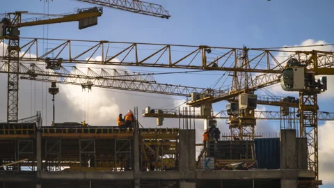 Cranes working day and night on construction of the housing estate in former  Stock Footage 86260337