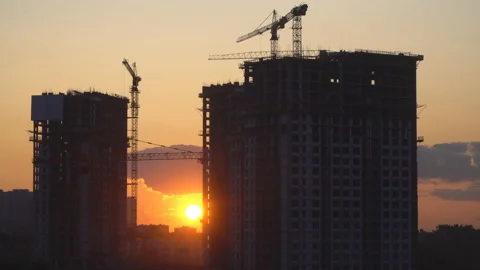 Cranes working day and night on construction of the housing estate in former  Stock Footage 113775600