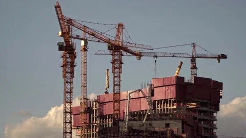 Cranes working day and night on construction of the housing estate in former  Stock Footage 154775355