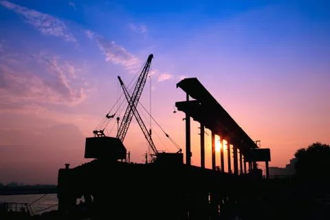 Cranes working at sunset Stock Photos