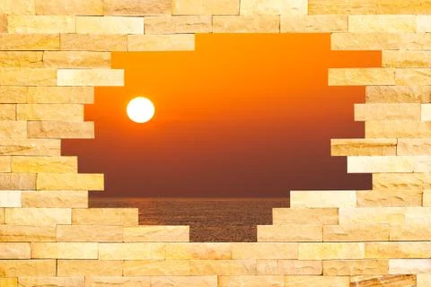 Crashed brick wall with beautiful sun set over the sea behind Ilustración de archivo