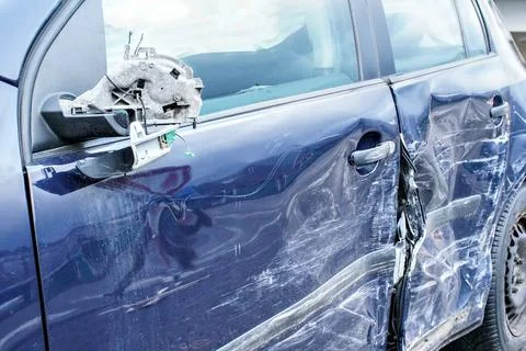 Crashed car, detail on side mirror and door - metal plates deformed after ... Stock Photos
