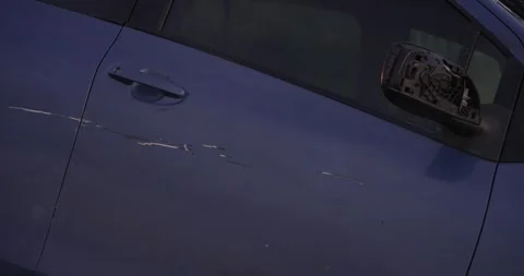 Crashed car with scrathes and broken rear view mirror Stock Footage 277385380