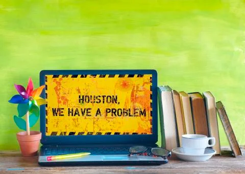 Crashed computer,home office, displaying message Houston We Have A Problem Stock Photos