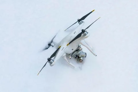 The crashed Drone. Fallen in snow. Phantom 3. Stock Photos