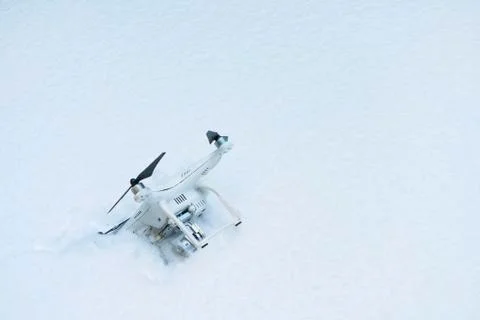 The crashed Drone. Fallen in snow. Phantom 3. Stock Photos