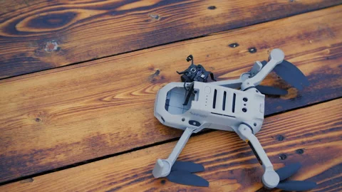 Crashed drone on the old wooden background with a broken camera. Stock Footage 168919554