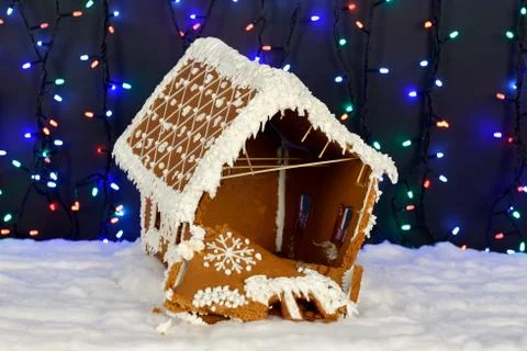 The crashed hand-made eatable gingerbread house, snow decoration Stock Photos
