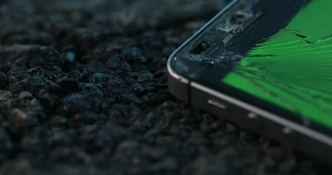 Crashed smartphone rests on the road's asphalt. Stock Footage 263077147