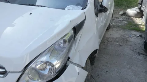 A crashed white car with a dented left side Stock Footage 152974538