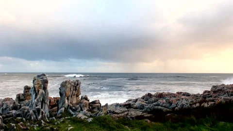 Crashing wave explodes impressively against jagged rocks of Hermanus Stock Footage 280654365