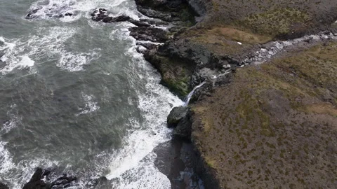Crashing Waves and Basalt Shoreline in Southeastern Iceland, dolly and tilt shot Stock Footage 337498732
