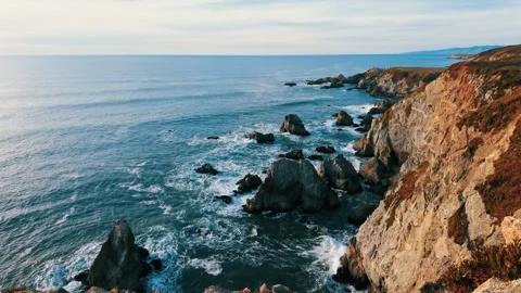 Crashing waves meet the rugged cliffs of Bodega Head at sunset Stock Footage 330761588