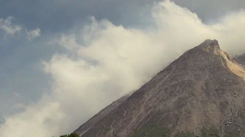 The crater of an active volcano emits white smoke Stock-Footage 143529888