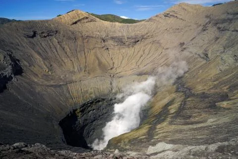 Crater inside of active volcano Mount Bromo with smoke coming out. Stock Photos