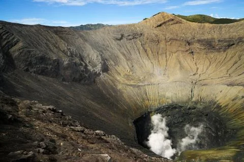 Crater inside of active volcano Mount Bromo with smoke coming out. Foto stock