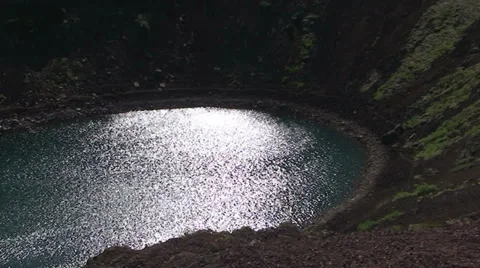 Crater lake with sun reflection, pan 스톡 동영상 37715926