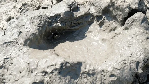 Crater of mud volcano bursting bubbles with natural gas. Stock Footage 120271568