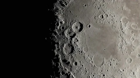 The craters and surface of the moon is lightened slowly. Close up view of moon Stock Footage