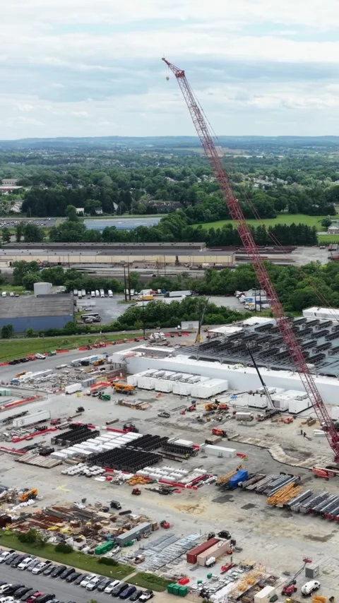 A crawler crane stands over the laydown yard of a data center build in Stock Footage 345728086