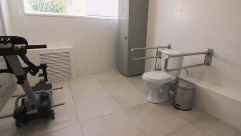 Crawler elevator for people in wheelchairs placed in restroom Stock Footage 295665906