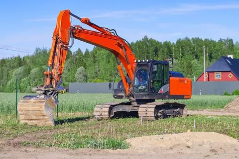 Crawler excavato front view digging a sewer trench Stock Photos