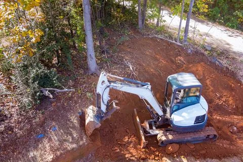 Crawler excavator buckets digging the ground during earthmoving works at Stock Photos