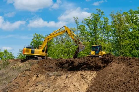 Crawler excavator front view digging on demolition site Stock Photos