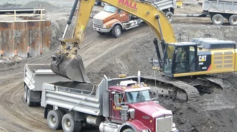 Crawler Excavator Loading Truck In Commercial Development Stock Footage 42394572