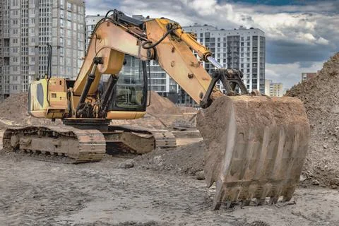 Crawler Excavator Machine Unloading Sand or Soil at Construction Area Backgro Photos