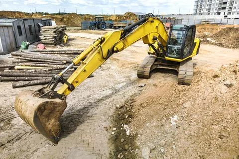 Crawler Excavator Machine Unloading Sand or Soil at Construction Area Backgro Stock Photos