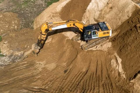Crawler excavator while working. Producing earthworks. Stock Photos