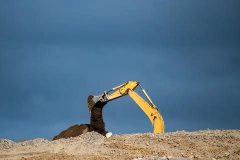 Crawler excavator working on a highway construction site Stock Photos