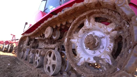 Crawler tracks of a plowing tractor and a field in early spring, a plowed field  Stock Footage 156076555