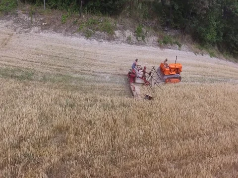 Crawler tractor with old harvester Stock Footage